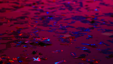 Close-Up-Of-Sparkling-Confetti-On-Floor-Of-Nightclub-Bar-Or-Disco-With-Flashing-Strobe-Lighting-1